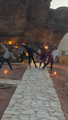 a group of people are playing on a stone road at Bubble RumCamp in Wadi Rum