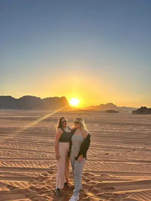 two women standing in the desert at sunset at Bubble RumCamp in Wadi Rum