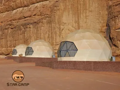 two domes in front of a rock wall at Star Camp in Wadi Rum