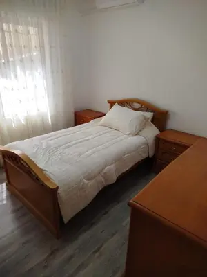 a bedroom with a large bed with two night stands at Executive Apartments in Amman