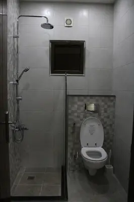 a bathroom with a toilet and a shower stall at Executive Apartments in Amman