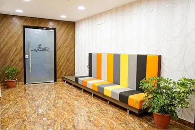 a lobby with a bench in front of a door at flamingo hotel irbid in Zabdah