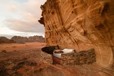 a stone fireplace in the middle of the desert at Wadi Rum Cave Camping in Wadi Rum