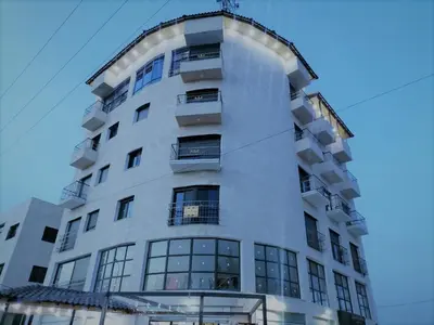 a tall white building with a lot of windows at For Women Only - للنساء فقط in Umm el ‘Amad