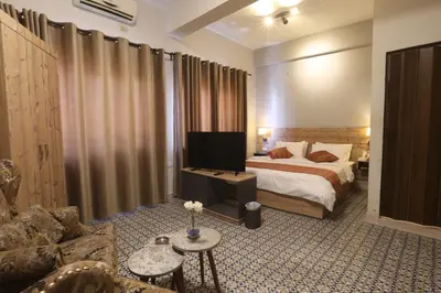 a bedroom with a bed and a tv in a room at Riviera Hotel in Amman