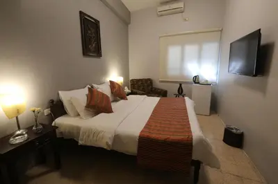 a bedroom with a large bed and a television at Riviera Hotel in Amman