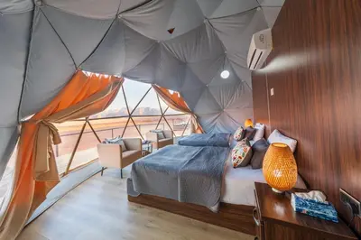 a room with a bed in a tent at SunCity Camp in Wadi Rum