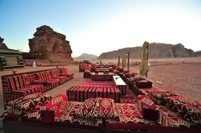 a group of tables and chairs in the desert at SunCity Camp in Wadi Rum