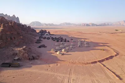 an aerial view of a group of people in the desert at SunCity Camp in Wadi Rum