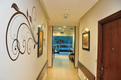 a hallway with graffiti on the walls of a building at Bashtamal Hotel Suites in Amman