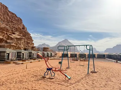 a playground in the desert with mountains in the background at Sunrise Luxury Camp in Wadi Rum