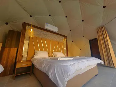 a bedroom with a large bed in a tent at Sunrise Luxury Camp in Wadi Rum