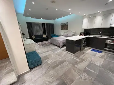 a kitchen and a bedroom with a bed and a sink at Luxury Studio DAMAC TOWER - 1 BEDROOM -JORDAN in Amman