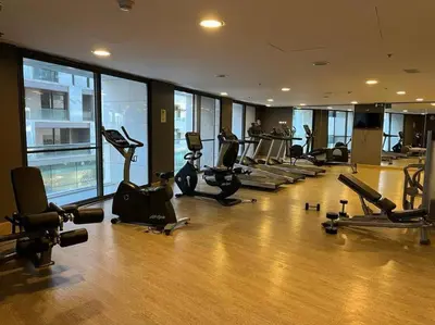 a gym with a bunch of exercise equipment in a building at Luxury Studio DAMAC TOWER - 1 BEDROOM -JORDAN in Amman