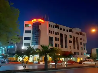 a building with a neon sign on top of it at Amman Orchid Hotel in Amman