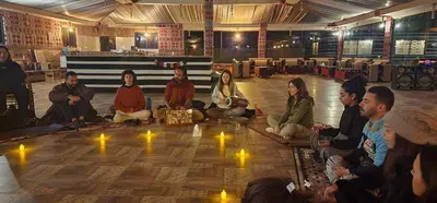 a group of people sitting on the floor with lights at Montana Camp wadi rum in Wadi Rum
