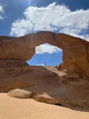 an arch in a rock formation in the desert at Wadi Rum albasli in Wadi Rum