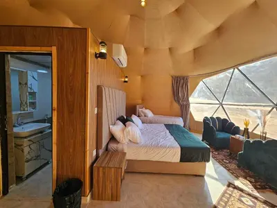 a bedroom with a bed in a room with a window at Wadi Rum Oscar camp in Wadi Rum
