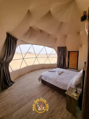 a bedroom with a bed in a tent at Wadi Rum Oscar camp in Wadi Rum