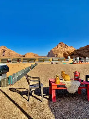 a chair and a table in the desert at Sun rise wadi rum camp in Wadi Rum