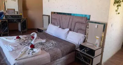 a bedroom with a large bed with a mirror at Sun rise wadi rum camp in Wadi Rum