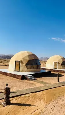 two domes in the middle of the desert at Sun rise wadi rum camp in Wadi Rum