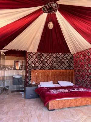 a bedroom with a canopy with a bed in it at Wadi Rum Story Camp in Wadi Rum