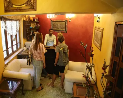 a group of people standing around a counter in a room at فندق الريفييرا in Ash Shumaysānī