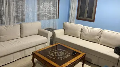 a living room with two couches and a coffee table at Only FAMILIES - Tala Bay Resort Aqaba - Seafront one bedroom apartment in Aqaba