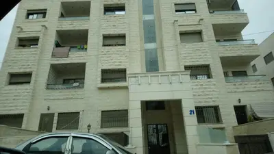 a building with a car parked in front of it at شقة مفروشة فرش فاخر ٣ غرف نوم في طبربور عمان in Amman