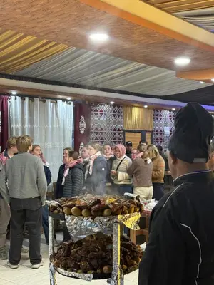 a group of people standing around a table with food at Orbit camp in Wadi Rum