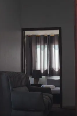 a mirror in a living room with a couch and a lamp at VALUE PLACE in Wadi Musa