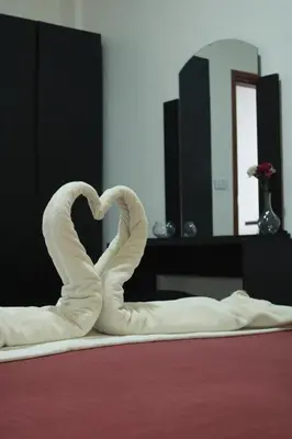 a heart made out of white towels on a bed at VALUE PLACE in Wadi Musa