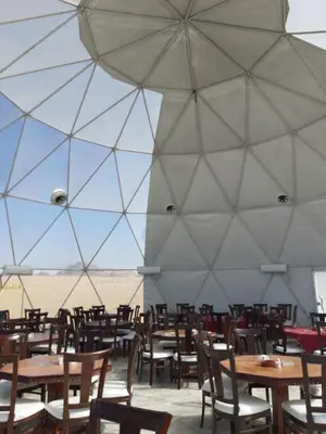 a dining room with tables and chairs in a tent at The Rock Camp Petra in Wadi Musa