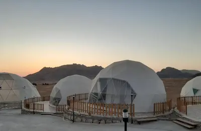a group of domes in a desert with mountains at The Rock Camp Petra in Wadi Musa
