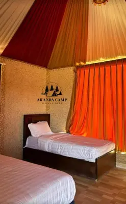 two beds in a room with a tent at Rum Aranda camp &Bubbles Hotel in Wadi Rum