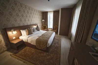 a hotel room with a bed and a table at Khan Khediwe Hotel in Amman