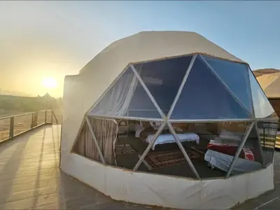 a dome tent with a bed inside of it at wadi rum land mars in Wadi Rum