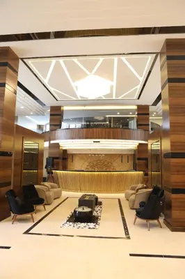 a lobby with couches and a large organ at فندق صحارى الخليج Sahara Gulf Hotel Apartments in Amman