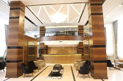 a lobby of a hotel with chairs and a bar at فندق صحارى الخليج Sahara Gulf Hotel Apartments in Amman