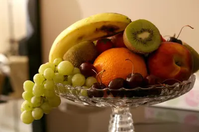 a glass bowl of fruit on a table at Century Park Hotel in Amman