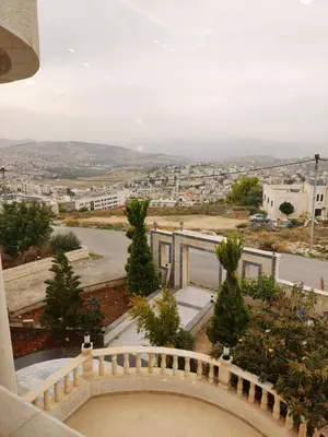 a view of a city from the balcony of a building at Lotus housing for furnished apartments in Jerash