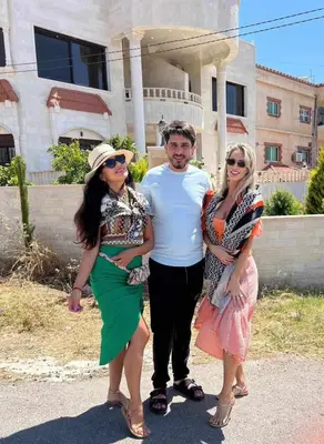 a man and two women standing in front of a building at Lotus housing for furnished apartments in Jerash