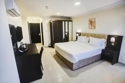 a hotel room with a bed and a desk and a bed sidx sidx sidx sidx at AQABA COAST HOTEL in Aqaba