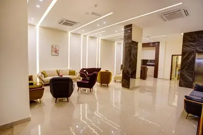 a lobby with couches and chairs in a building at AQABA COAST HOTEL in Aqaba