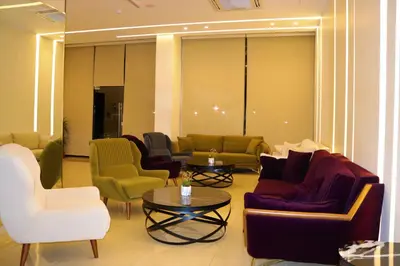 a lobby with couches and chairs and a table at AQABA COAST HOTEL in Aqaba