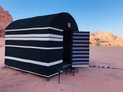 a black and white building in the desert at Wadi Rum Escape in Wadi Rum