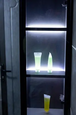 a lighted shelf with two cups and a glass at Wadi Rum Mirror Camp in Wadi Rum