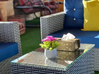 a table with a vase with flowers and a box at Petra Royal Ranch in Wadi Musa