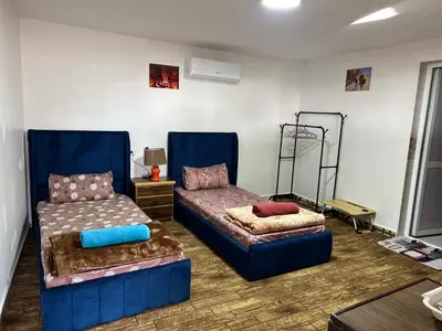 a room with two beds and a couch and a table at Petra Royal Ranch in Wadi Musa